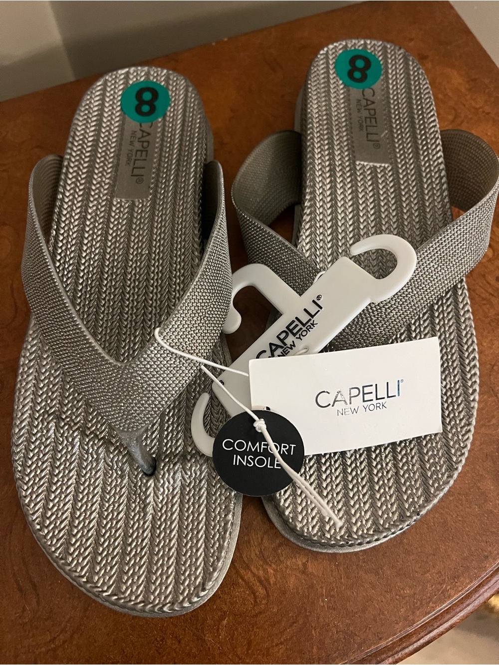 Capelli of New York Metallic Silver Woven Flip Flops - Women